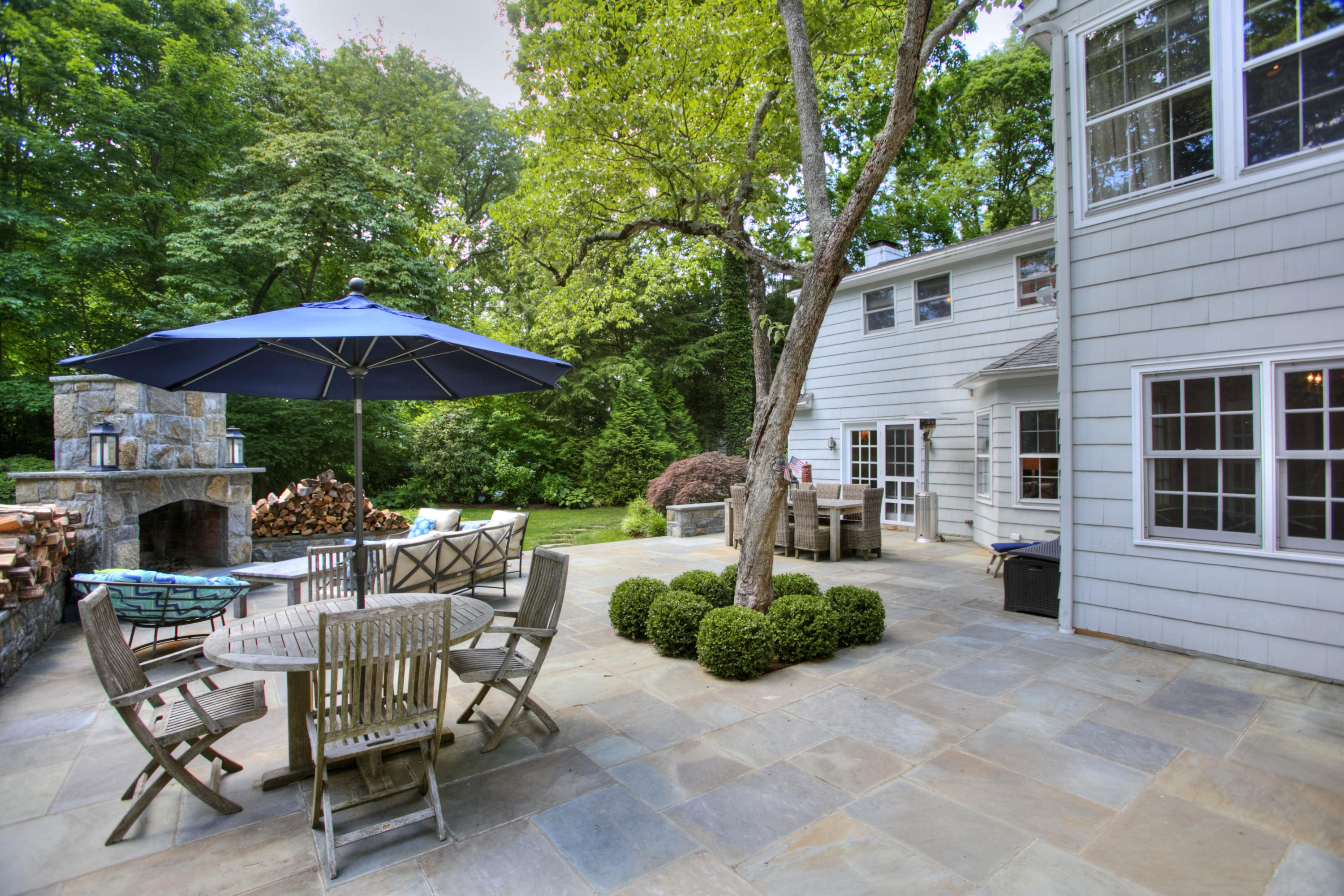17 Rocaton Road Darien, CT 06820 - Photo 25 of 26 a view of a patio with a table and chairs under an umbrella