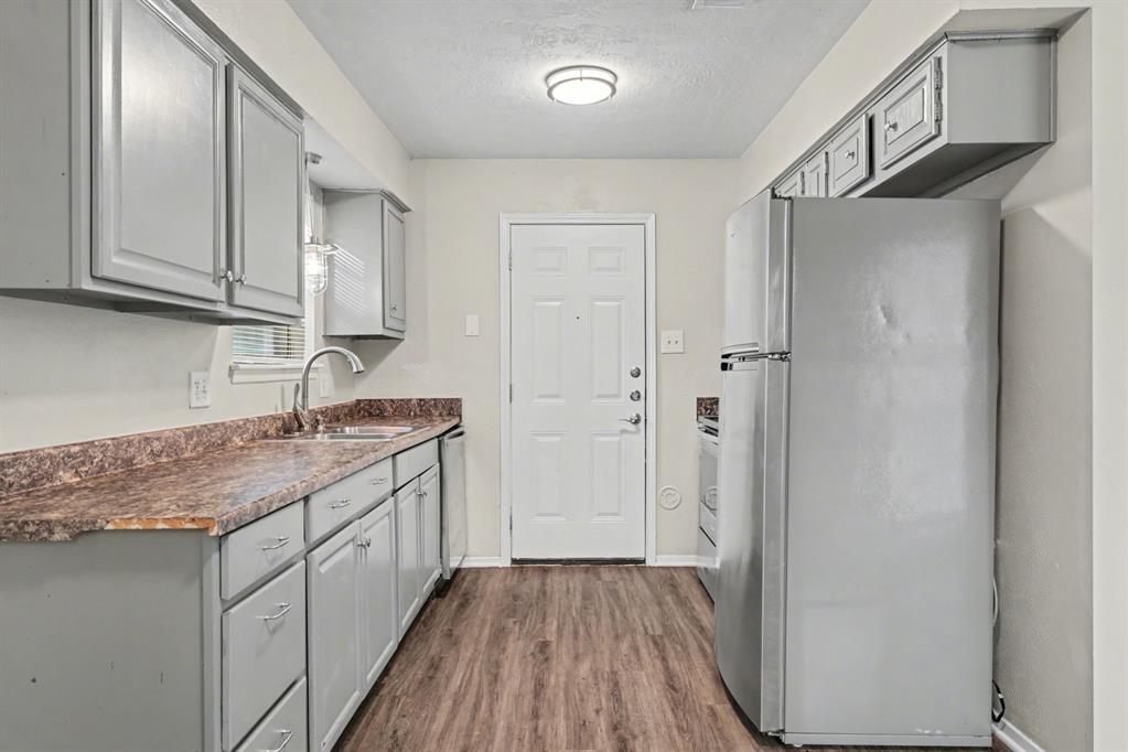 1321 North 7th Street Conroe, TX 77301 - Photo 10 of 17 a kitchen with a sink stove and cabinets
