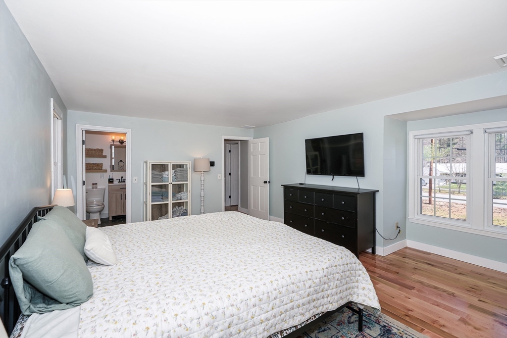 32 Reservoir Road Lunenburg, MA 01462 - Photo 21 of 42 a bedroom with a bed and a flat screen tv