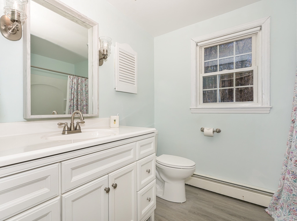 32 Reservoir Road Lunenburg, MA 01462 - Photo 28 of 42 a bathroom with a sink a toilet and a mirror