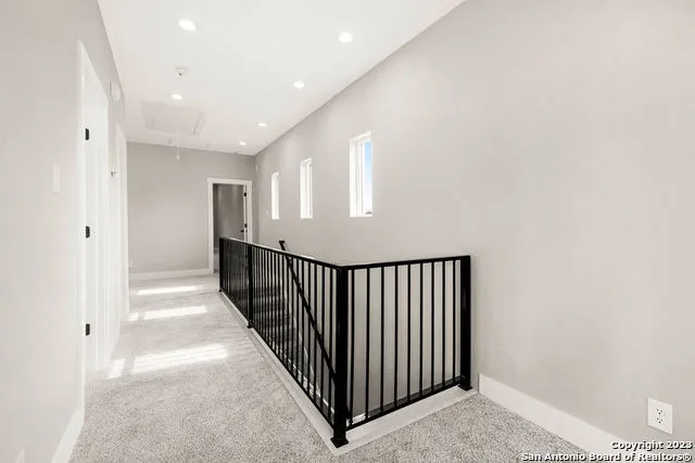 a view of a hallway with wooden floor and entryway
