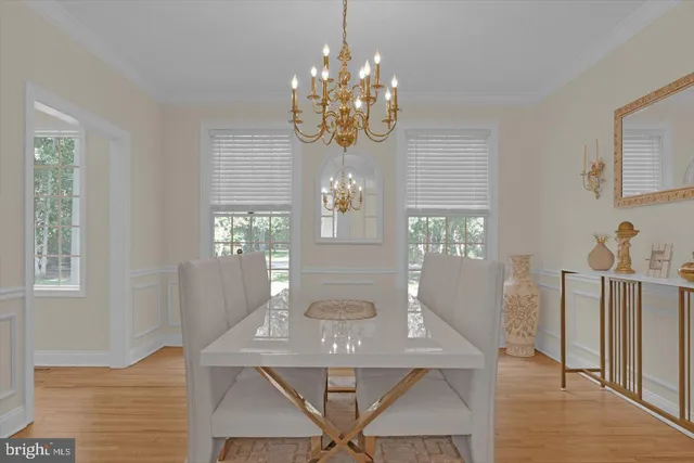a view of a dining room with furniture and chandelier