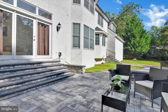 a view of a swimming pool with chairs and plants