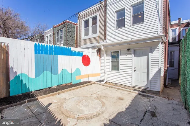 a view of a house with a backyard and a garage