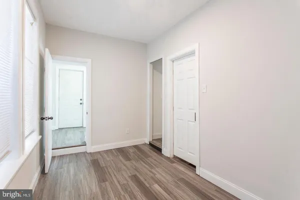 an empty room with wooden floor