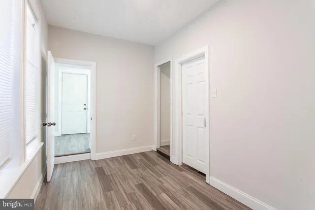 an empty room with wooden floor