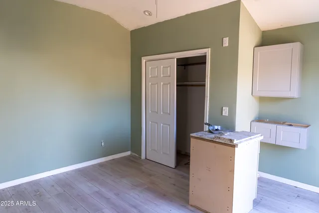 a room with cabinets and wooden floor