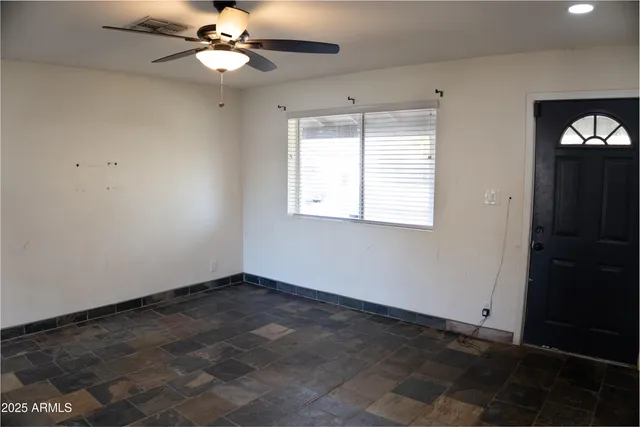 a view of an empty room with a window