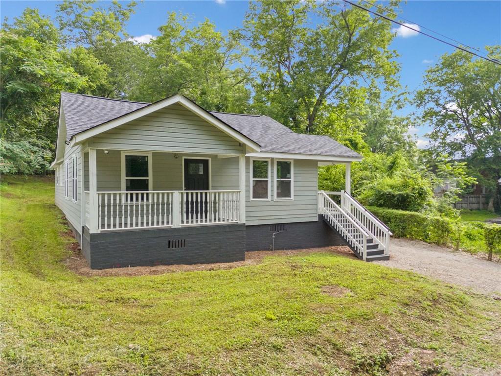 302 Wright Street Rome, GA 30161 - Photo 1 of 1 a front view of a house with yard and green space