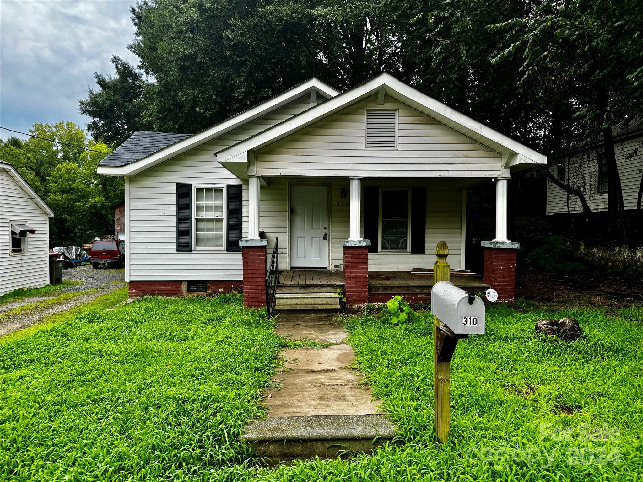 a front view of house with a garden and patio