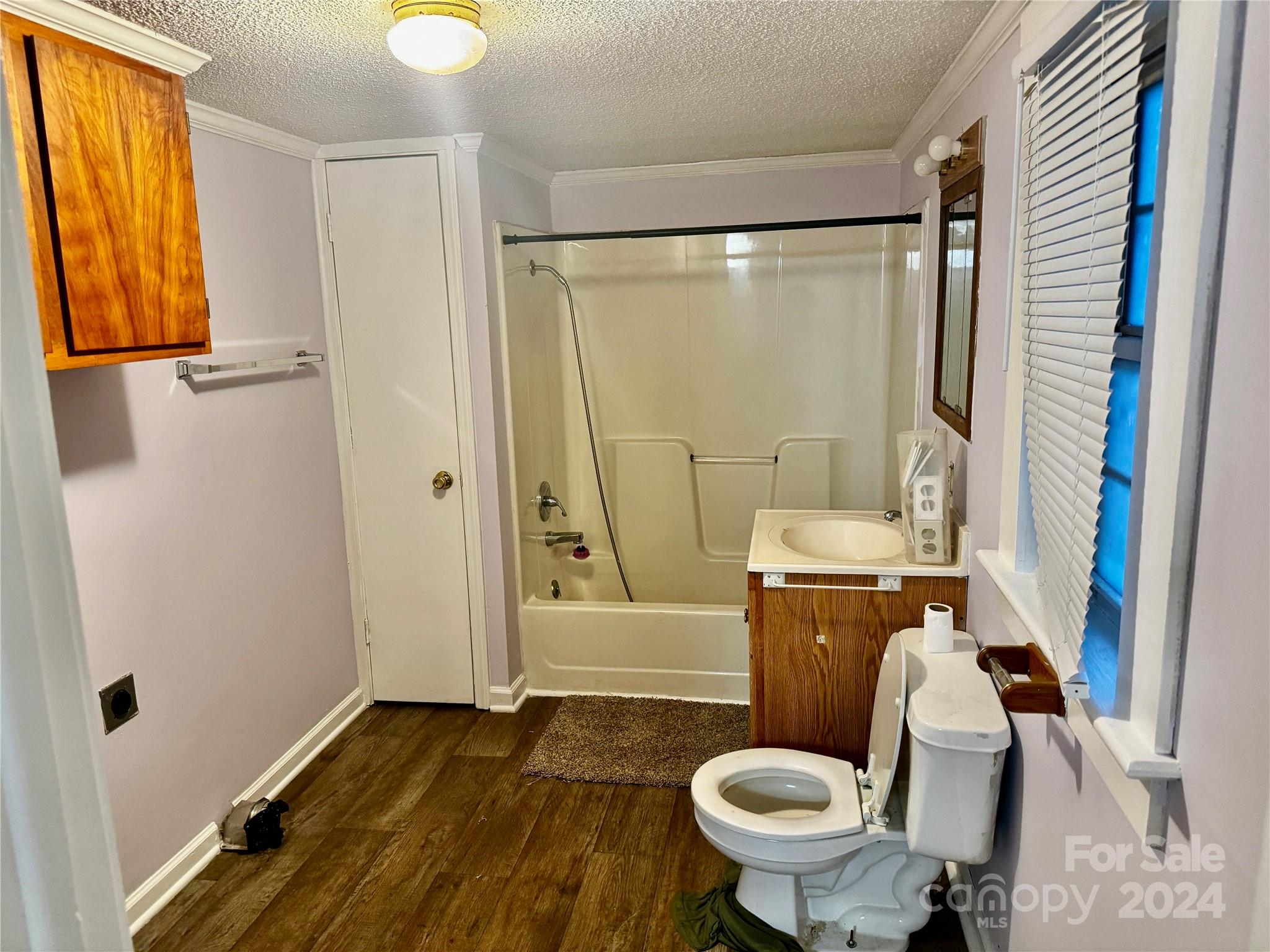 310 Pineview Street Kannapolis, NC 28083 - Photo 10 of 13 a white toilet sitting next to a bathroom sink and a shower