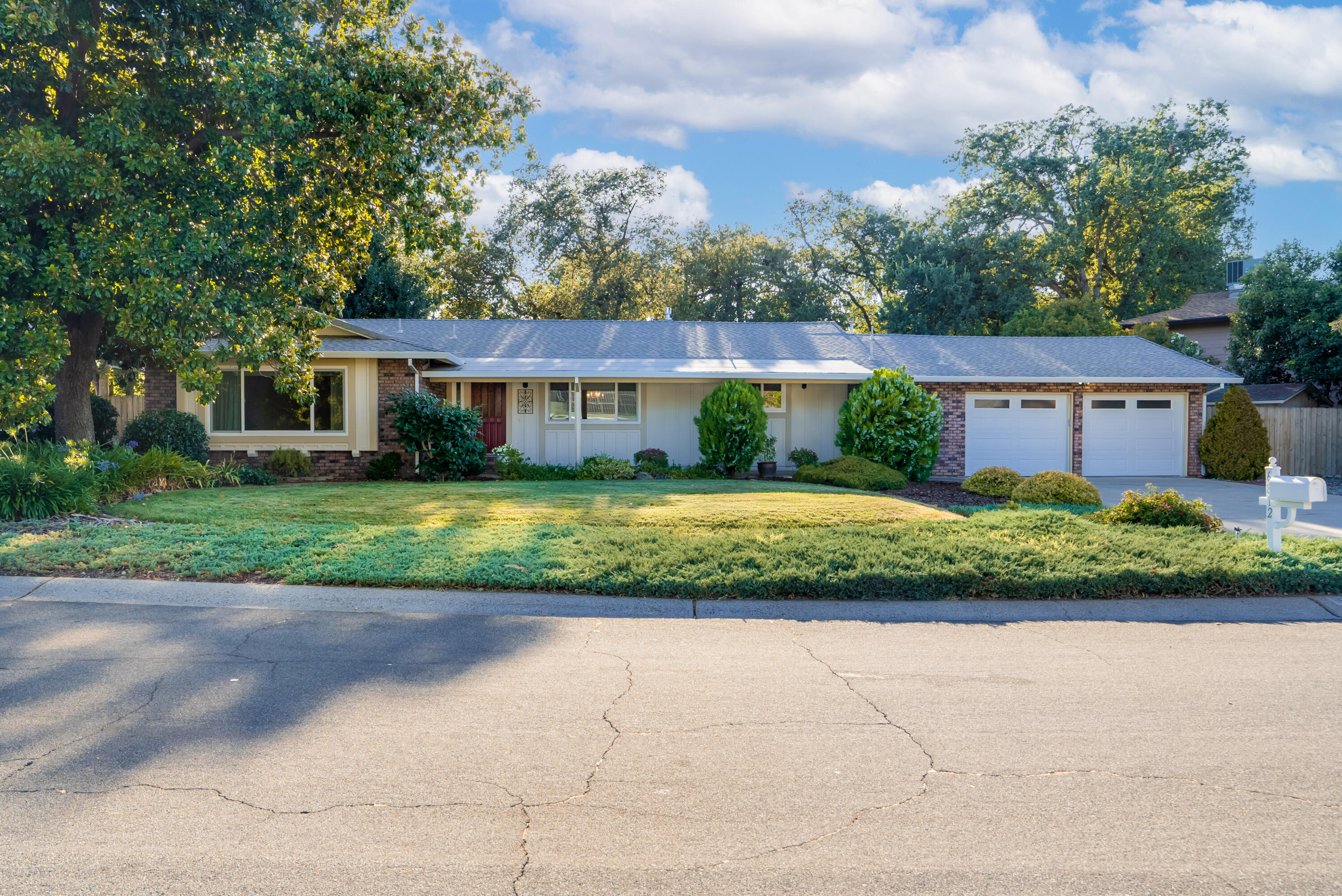 a front view of a house with a garden