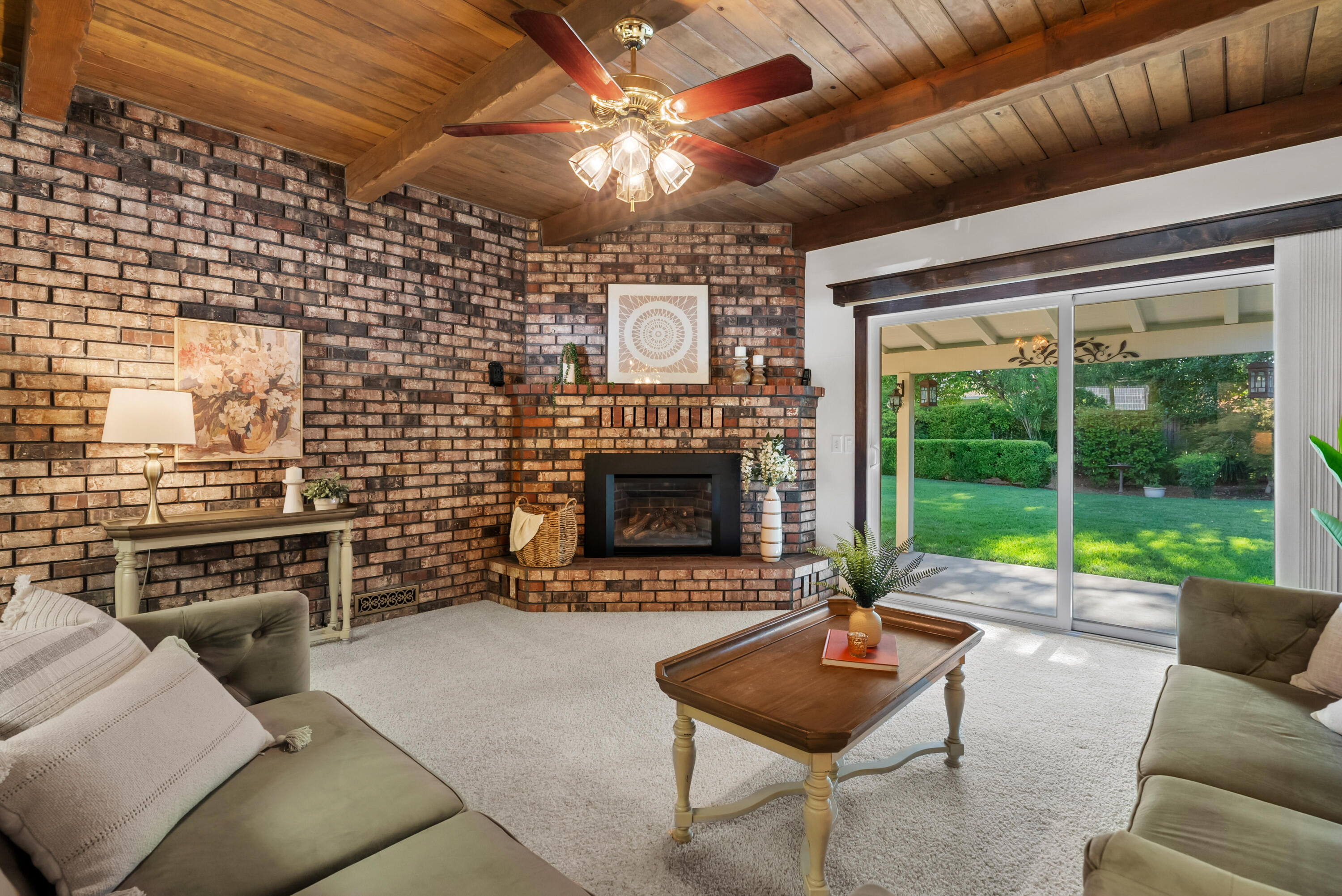 6812 Riata Drive Redding, CA 96002 - Photo 17 of 42 a living room with furniture a fireplace and a table