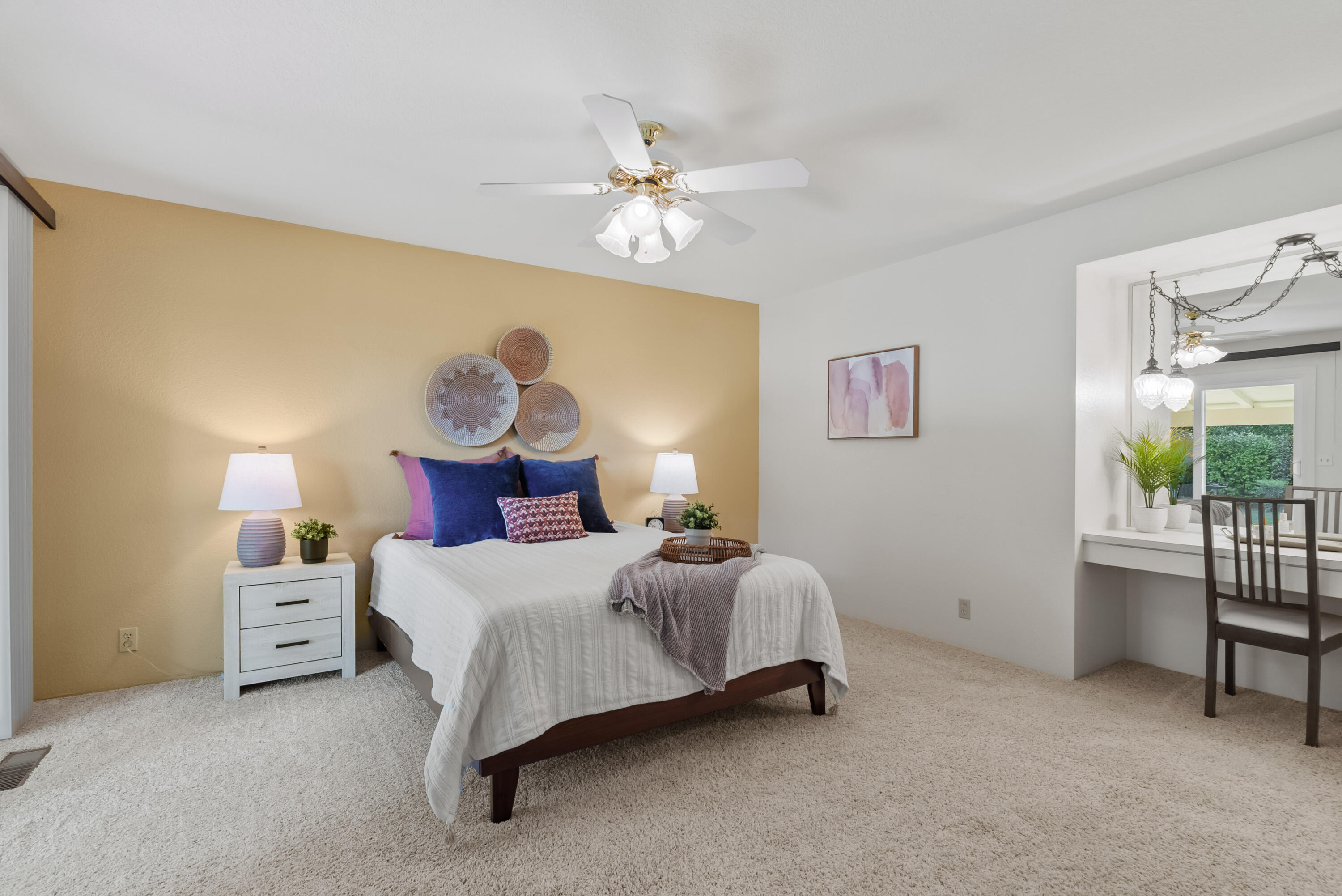 6812 Riata Drive Redding, CA 96002 - Photo 19 of 42 a bedroom with a bed and a chandelier