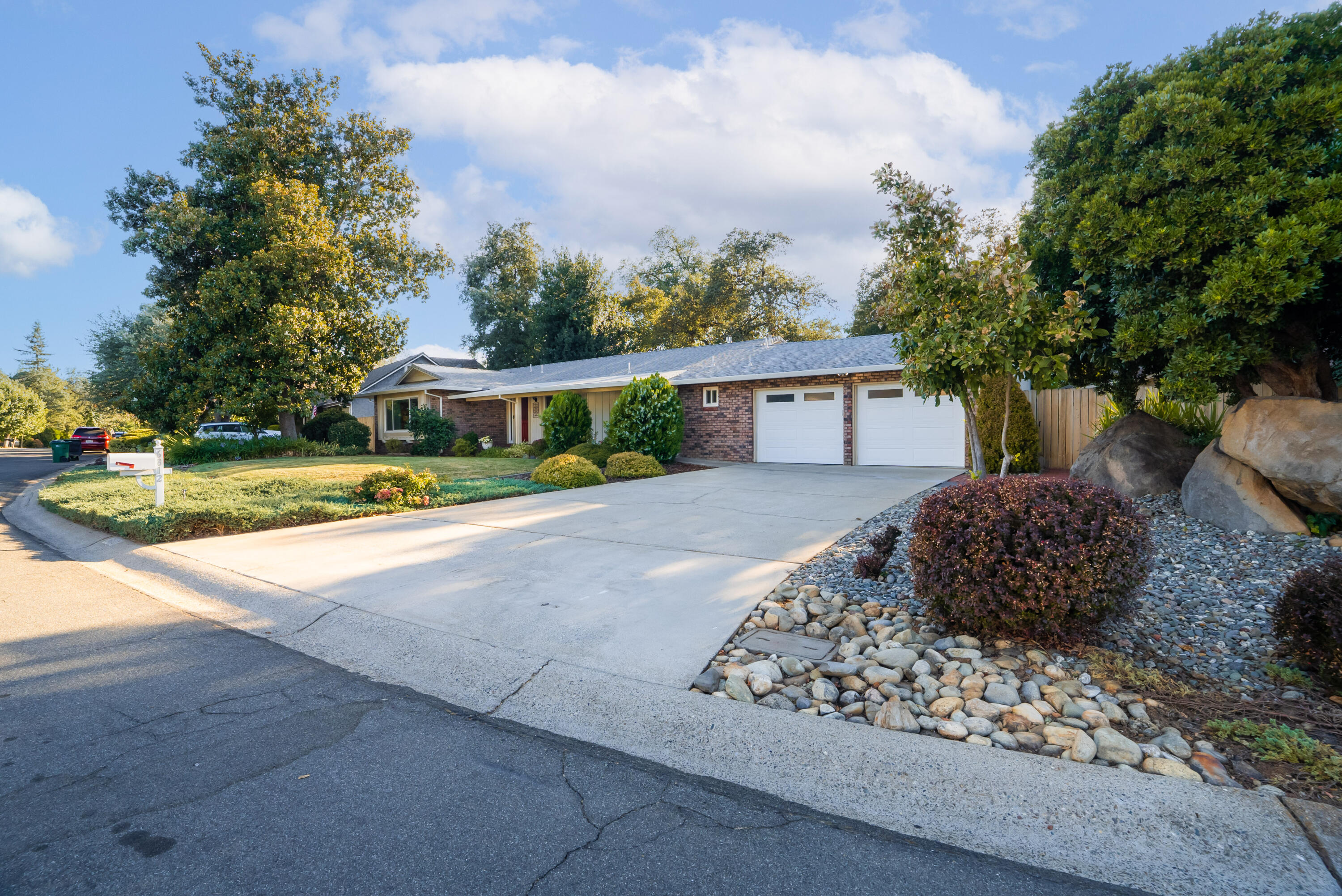 6812 Riata Drive Redding, CA 96002 - Photo 2 of 42 a view of a house with a yard and potted plants