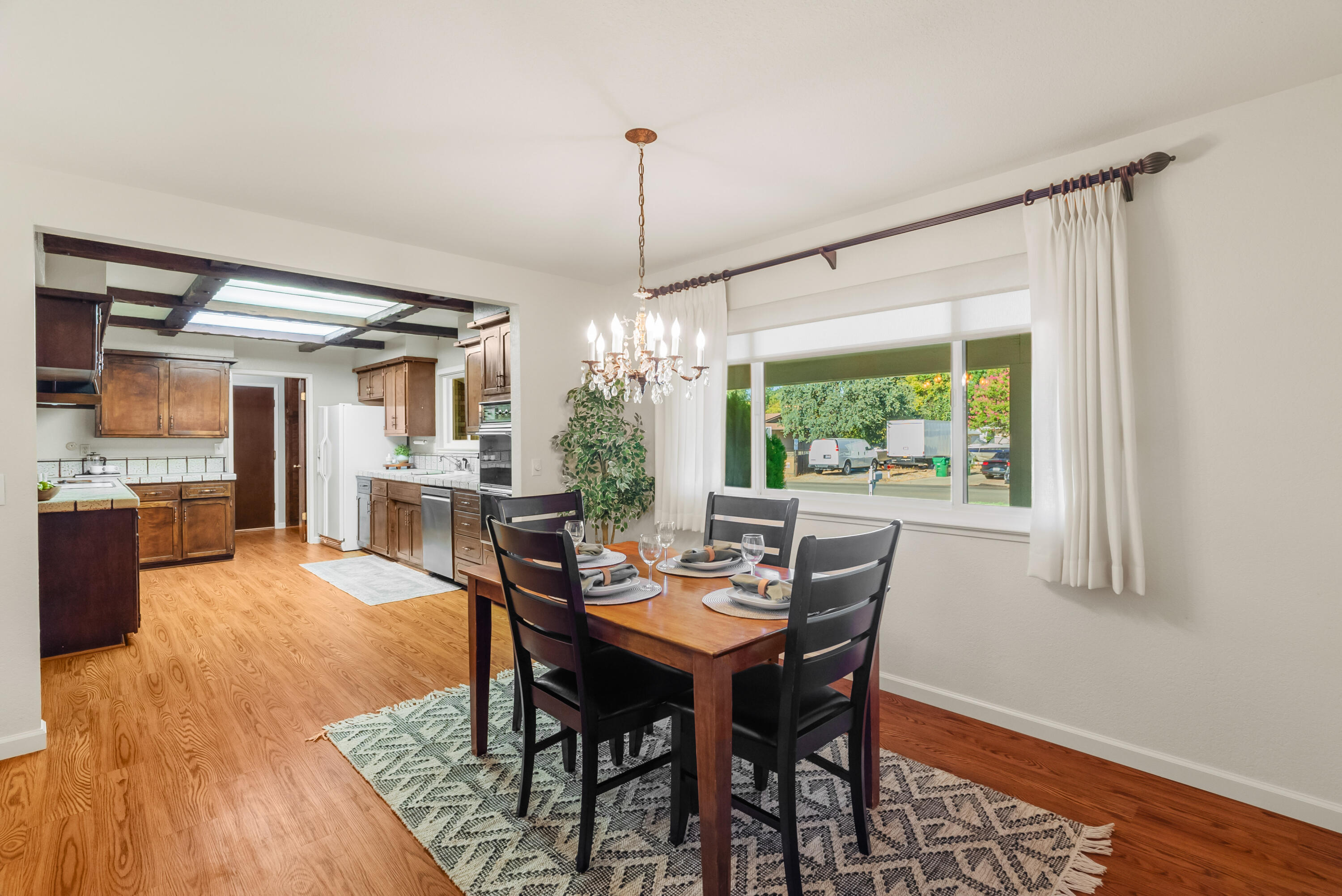 6812 Riata Drive Redding, CA 96002 - Photo 10 of 42 a dining room with furniture a chandelier and wooden floor