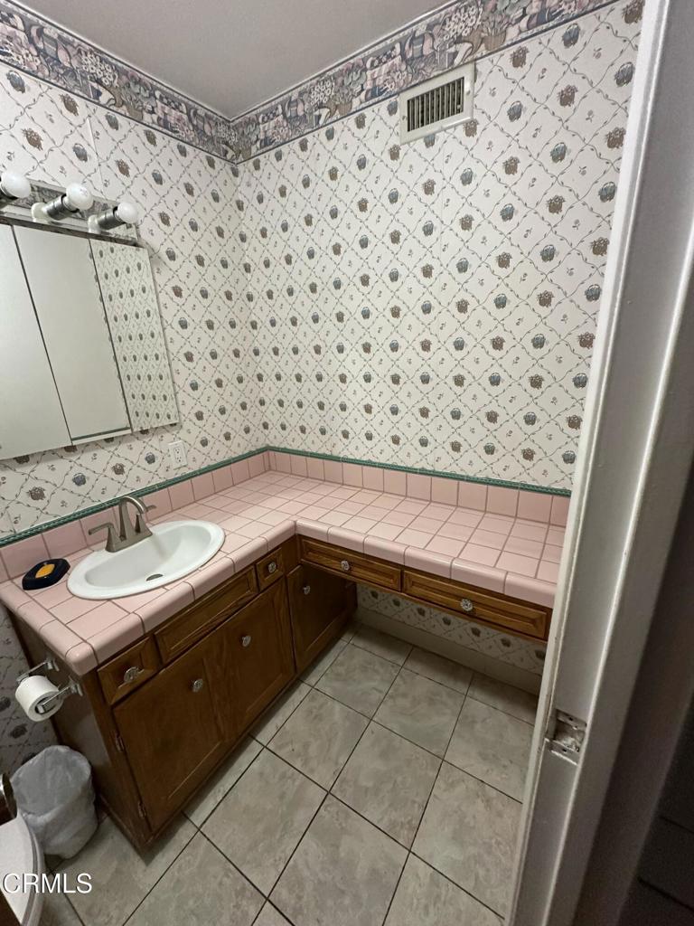 4591 Hempstead Street Simi Valley, CA 93063 - Photo 15 of 47 a bathroom with a sink and a mirror