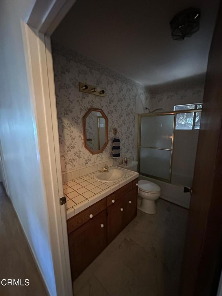 4591 Hempstead Street Simi Valley, CA 93063 - Photo 20 of 47 a bathroom with a granite countertop sink and a mirror