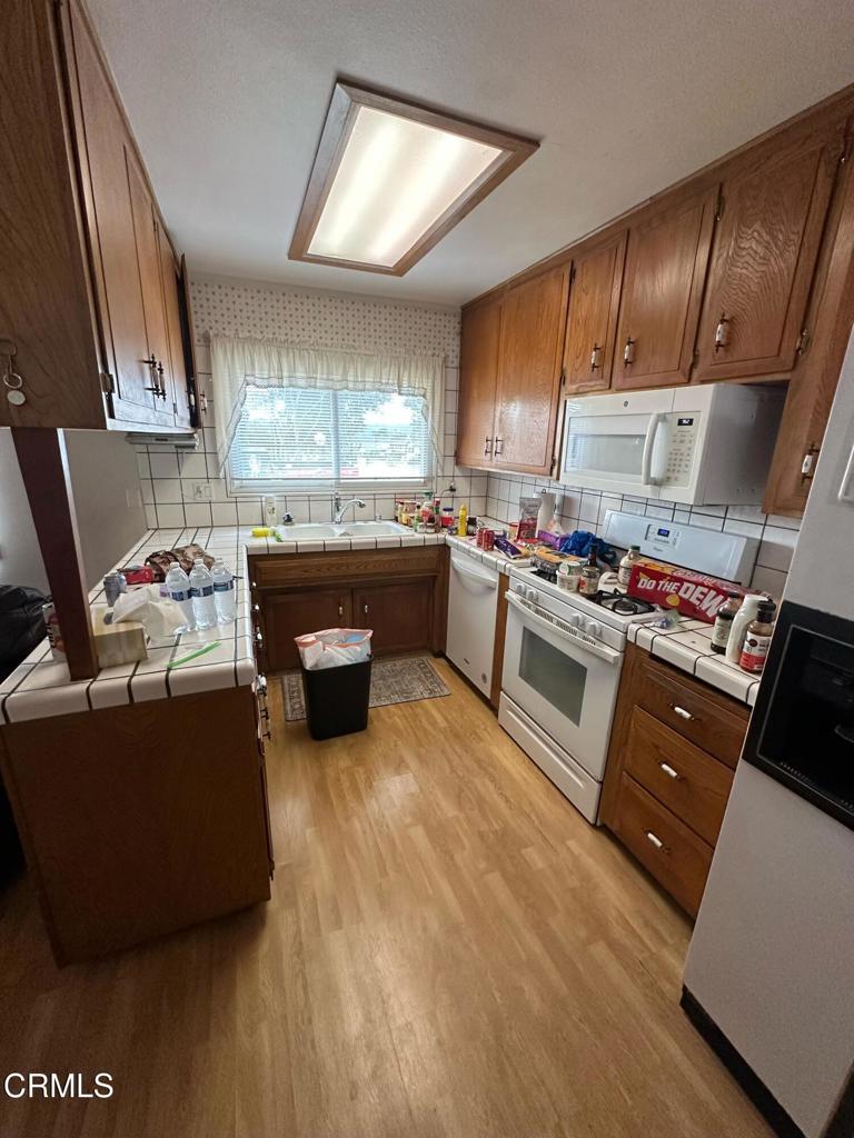 4591 Hempstead Street Simi Valley, CA 93063 - Photo 2 of 47 a kitchen with kitchen island wooden cabinets and stainless steel appliances