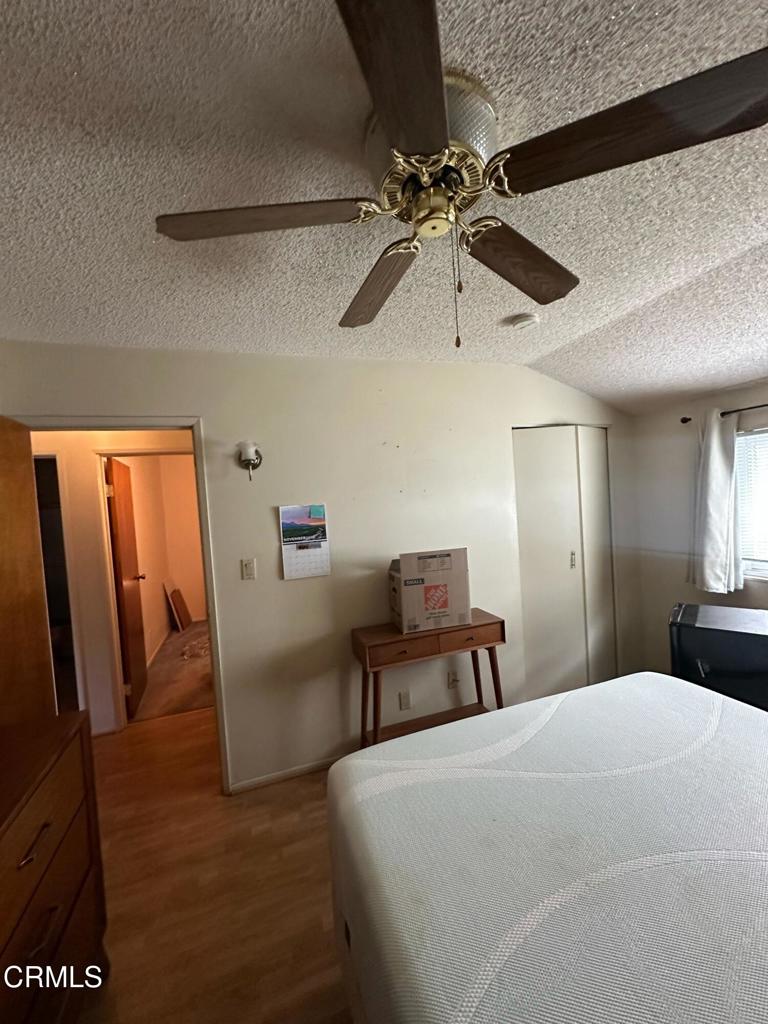 4591 Hempstead Street Simi Valley, CA 93063 - Photo 25 of 47 a bedroom with a bed and a chandelier