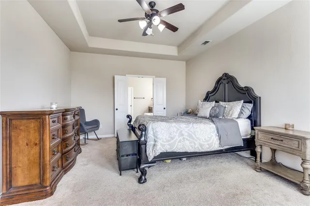 a bedroom with a bed and cabinets