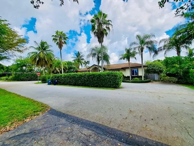 a front view of a house with a yard and a garage