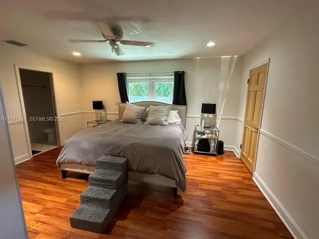 a bed room with a bed and a flat screen tv