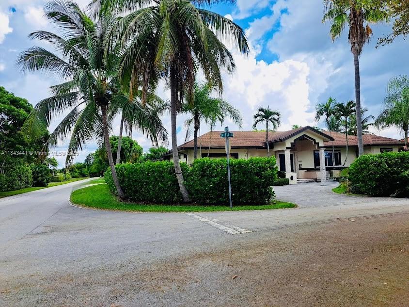 10375 Southwest 111th Street Miami, FL 33176 - Photo 5 of 30 a view of a house with palm trees and a small yard