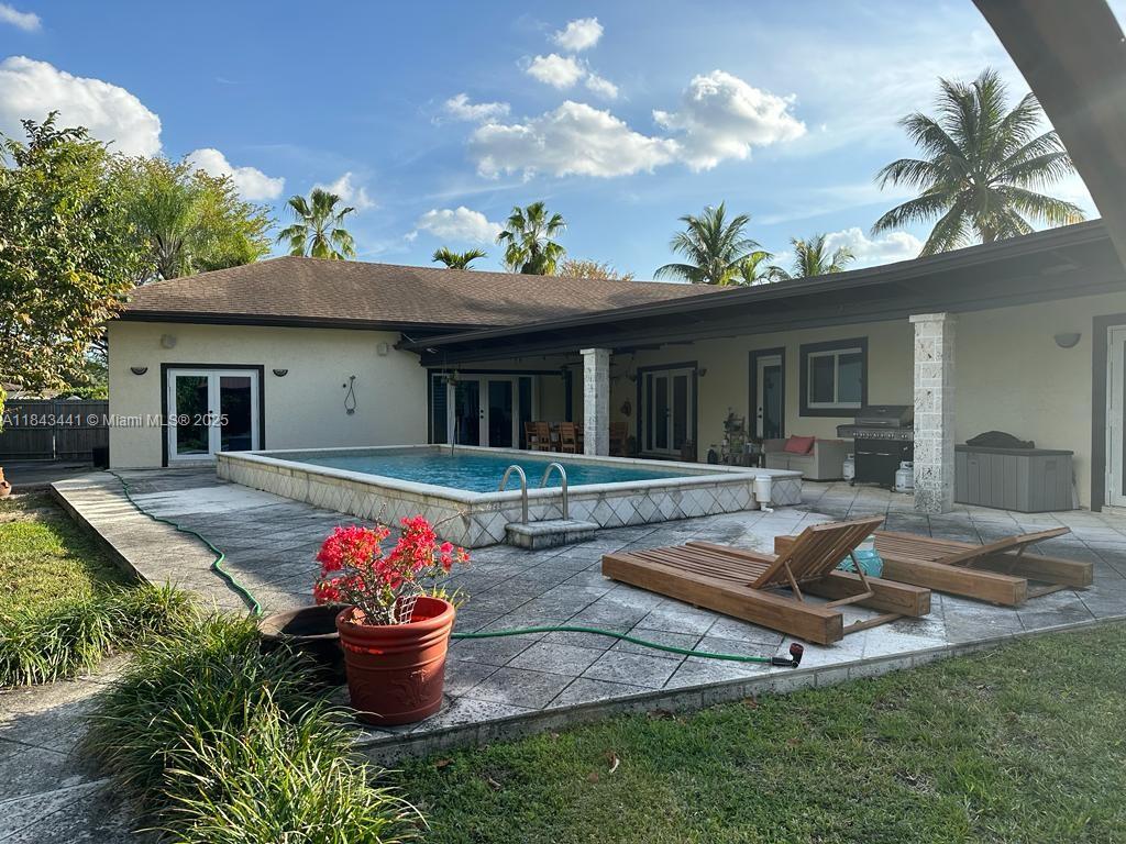 10375 Southwest 111th Street Miami, FL 33176 - Photo 6 of 30 a swimming pool with outdoor seating