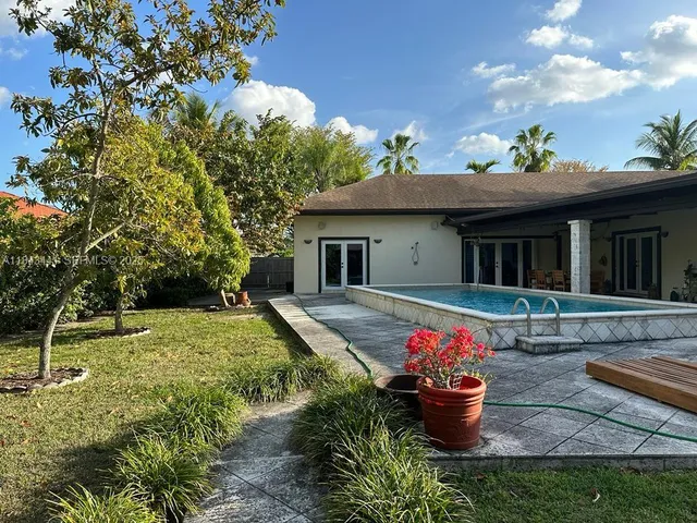 a front view of a house with a yard fountain and a fountain