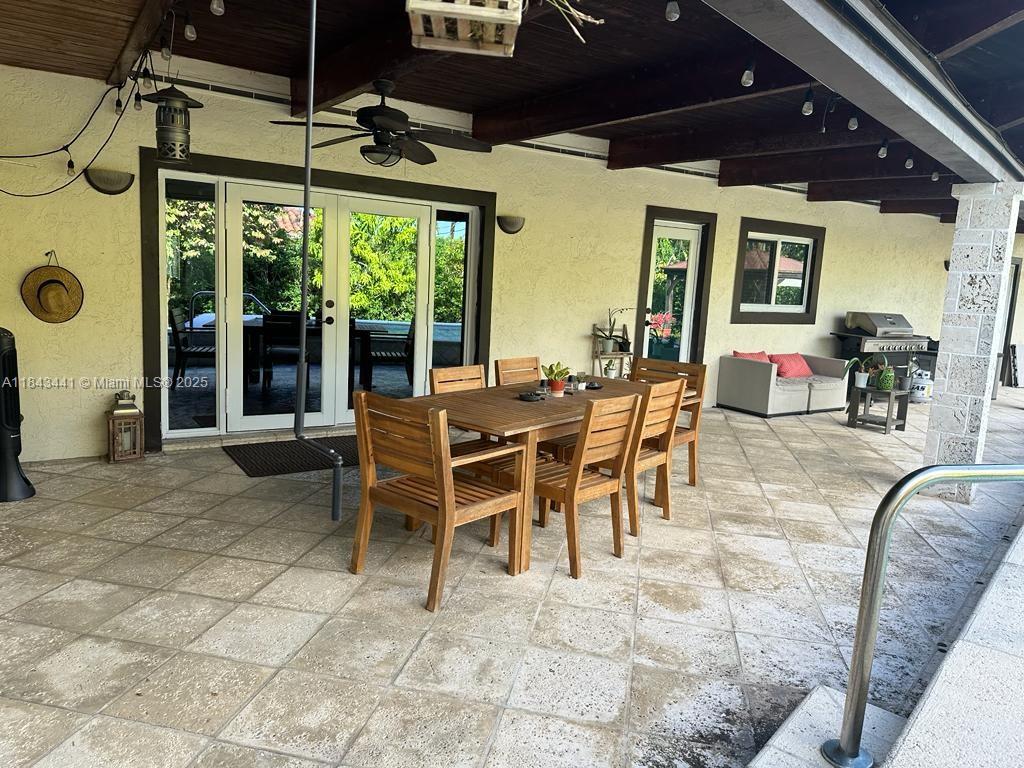 10375 Southwest 111th Street Miami, FL 33176 - Photo 9 of 30 a dining room with furniture and large windows