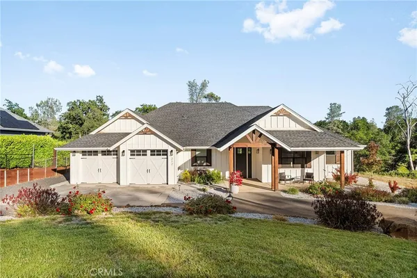a front view of a house with a garden