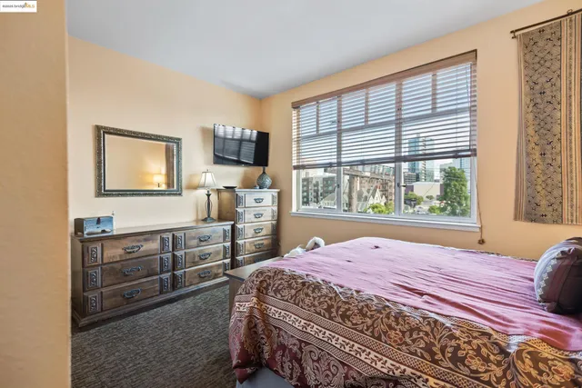 a bedroom with a bed and with furniture