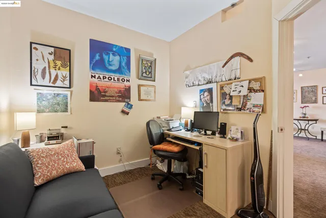 a view of a workspace with furniture and a bedroom