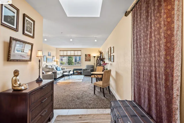 a living room with furniture and a painting on the wall