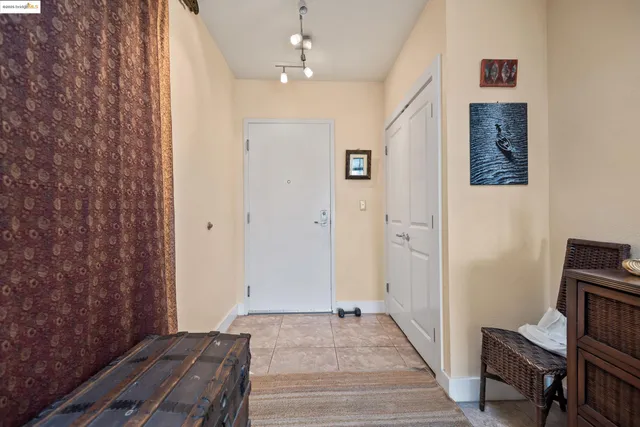 a view of a hallway with workspace and wooden floor