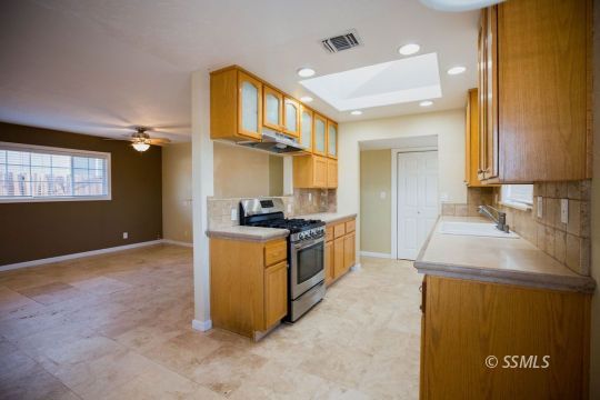 1233 South Ranger Street Ridgecrest, CA 93555 - Photo 12 of 30 a kitchen with stainless steel appliances granite countertop a sink and a stove top oven