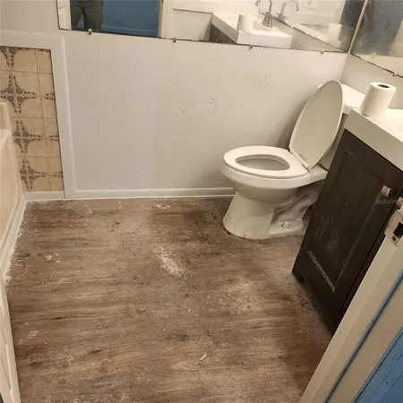 a white toilet sitting next to a shower