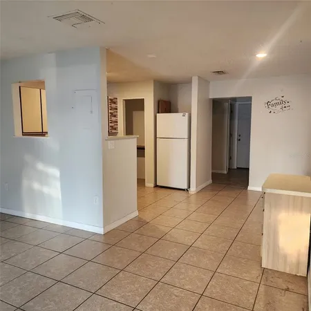 a view of kitchen with furniture and refrigerator