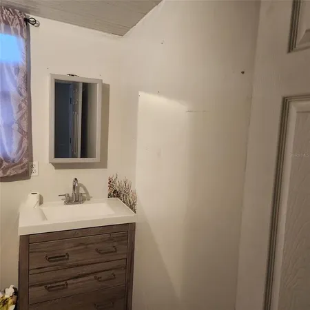 a bathroom with a sink vanity and mirror
