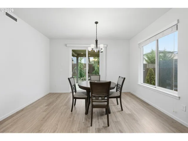 a dining room with furniture window outside view and wooden floor