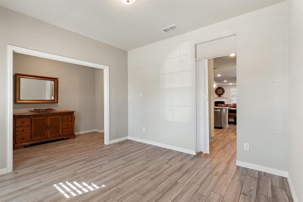 2012 Elara Drive Haslet, TX 76052 - Photo 11 of 34 a view of a hallway with wooden floor and a living room