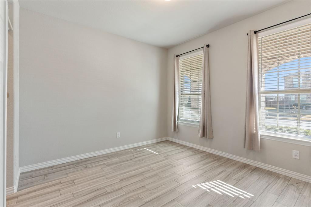 2012 Elara Drive Haslet, TX 76052 - Photo 12 of 34 a view of an empty room with wooden floor and a window