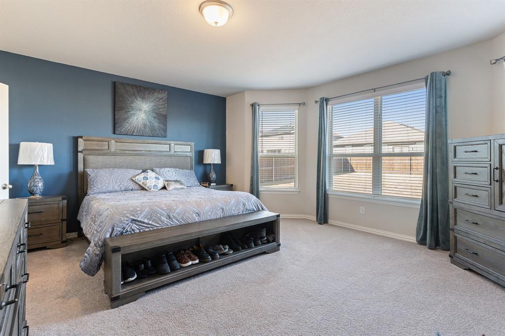 2012 Elara Drive Haslet, TX 76052 - Photo 14 of 34 a bed sitting in a spacious bedroom next to a window
