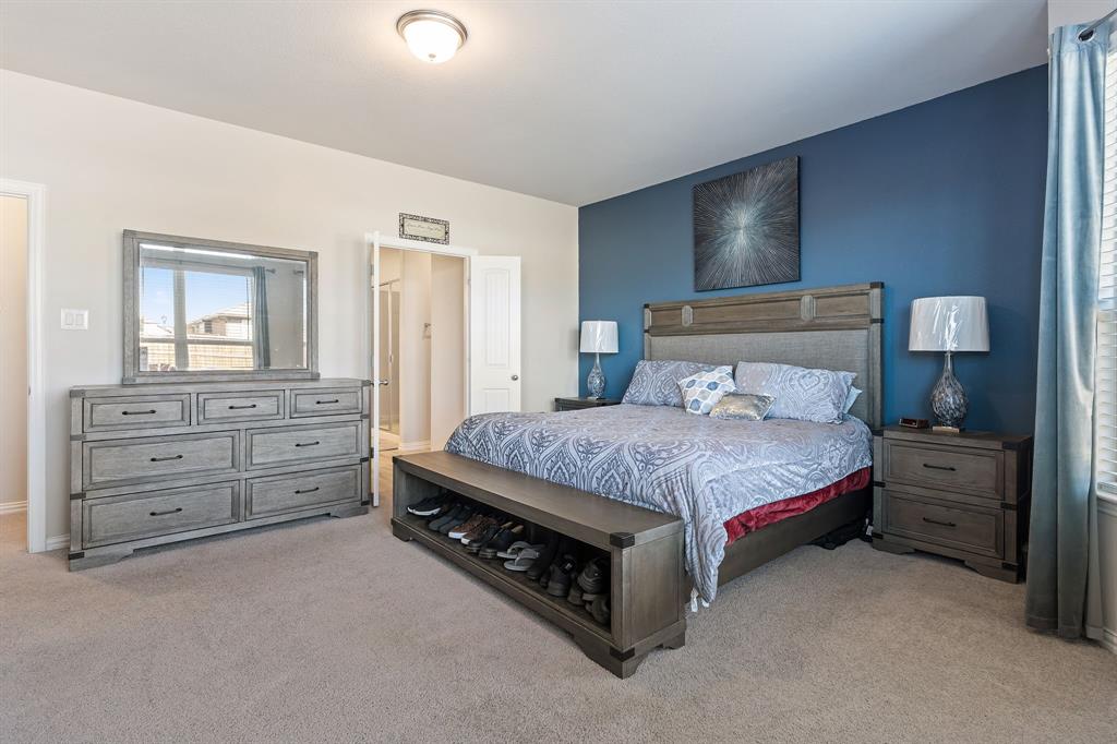 2012 Elara Drive Haslet, TX 76052 - Photo 15 of 34 a spacious bedroom with a bed and a dresser