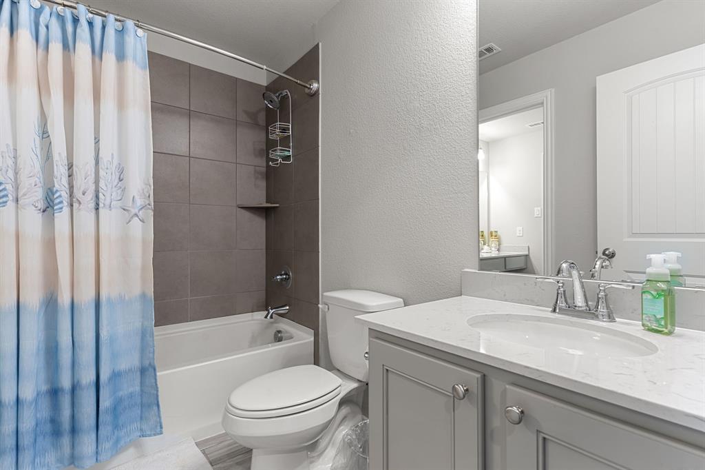 2012 Elara Drive Haslet, TX 76052 - Photo 24 of 34 a bathroom with a granite countertop sink a toilet and shower