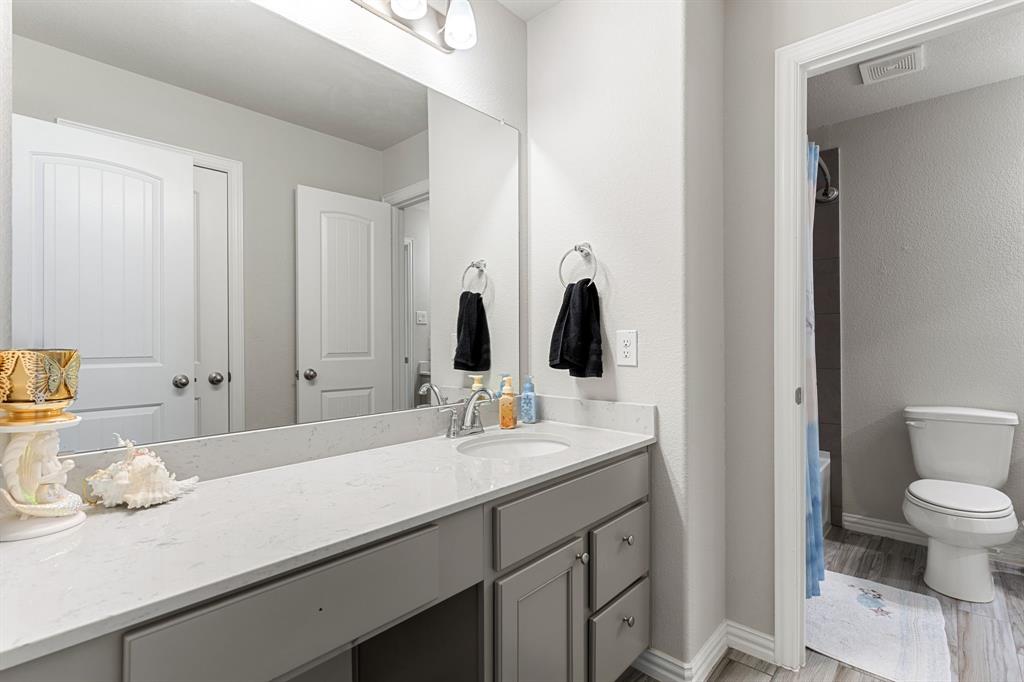 2012 Elara Drive Haslet, TX 76052 - Photo 26 of 34 a bathroom with a sink a toilet and shower
