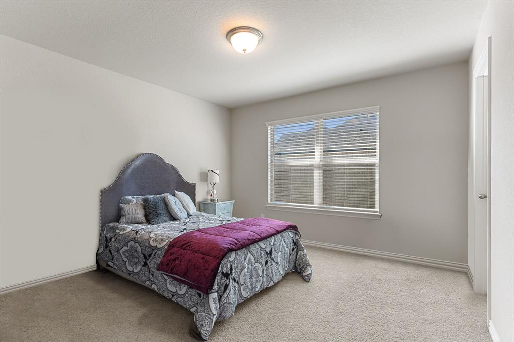 2012 Elara Drive Haslet, TX 76052 - Photo 27 of 34 a bedroom with a bed and a window