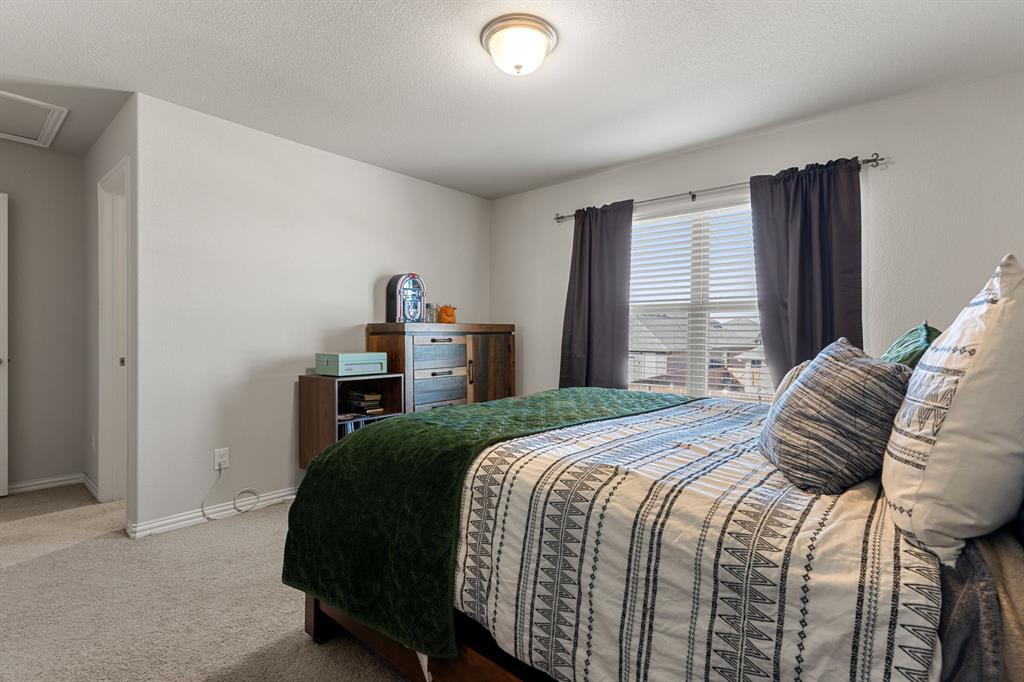 2012 Elara Drive Haslet, TX 76052 - Photo 29 of 34 a bedroom with a bed and a window