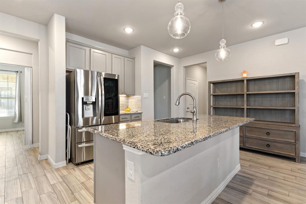 2012 Elara Drive Haslet, TX 76052 - Photo 5 of 34 a kitchen with kitchen island a counter top space and stainless steel appliances